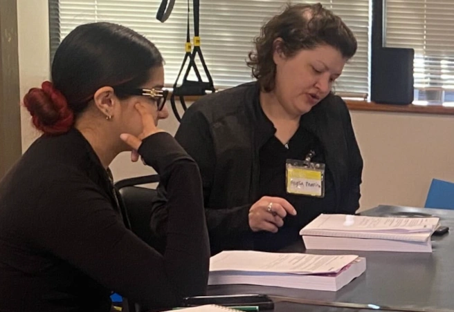 instructor reviewing written material with a student instructor reviewing written material with a student