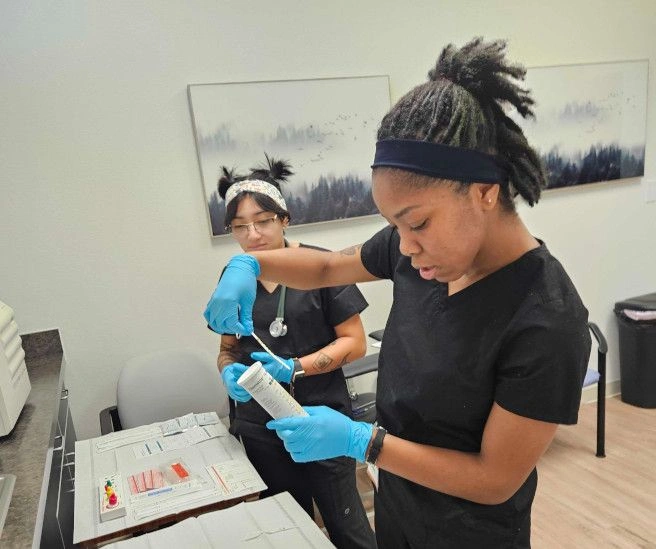 students working with medical assisting tools students working with medical assisting tools